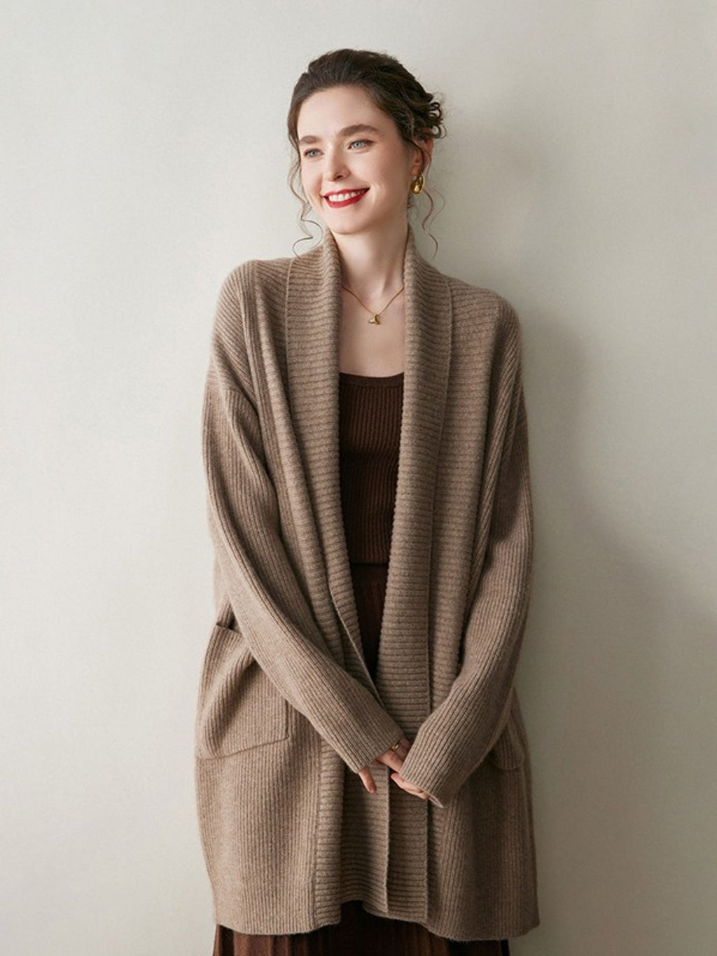 A stylish, mid-length knitted cardigan coat for women, designed with a sophisticated and elegant look perfect for autumn and winter.