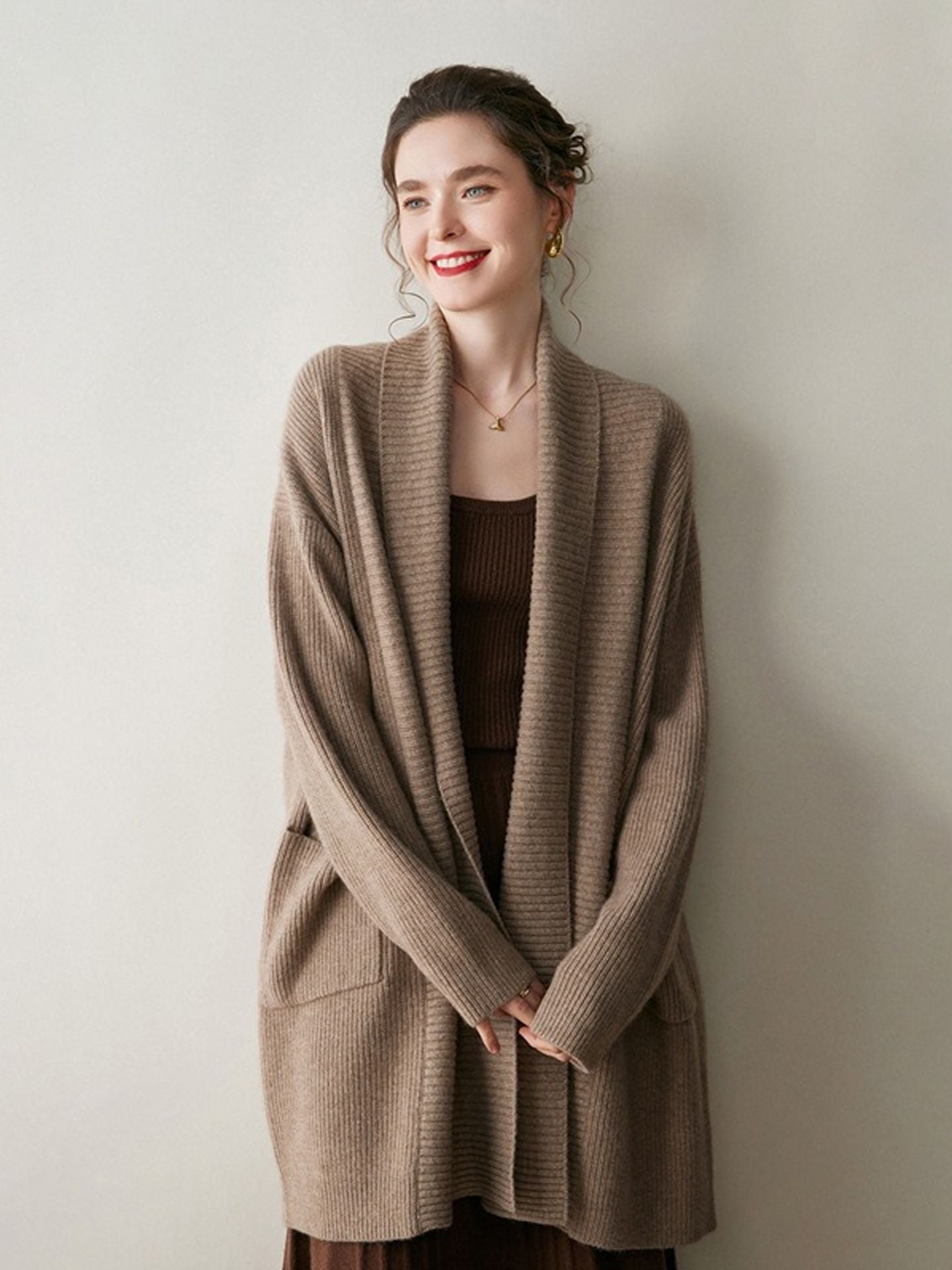 A stylish, mid-length knitted cardigan coat for women, designed with a sophisticated and elegant look perfect for autumn and winter.