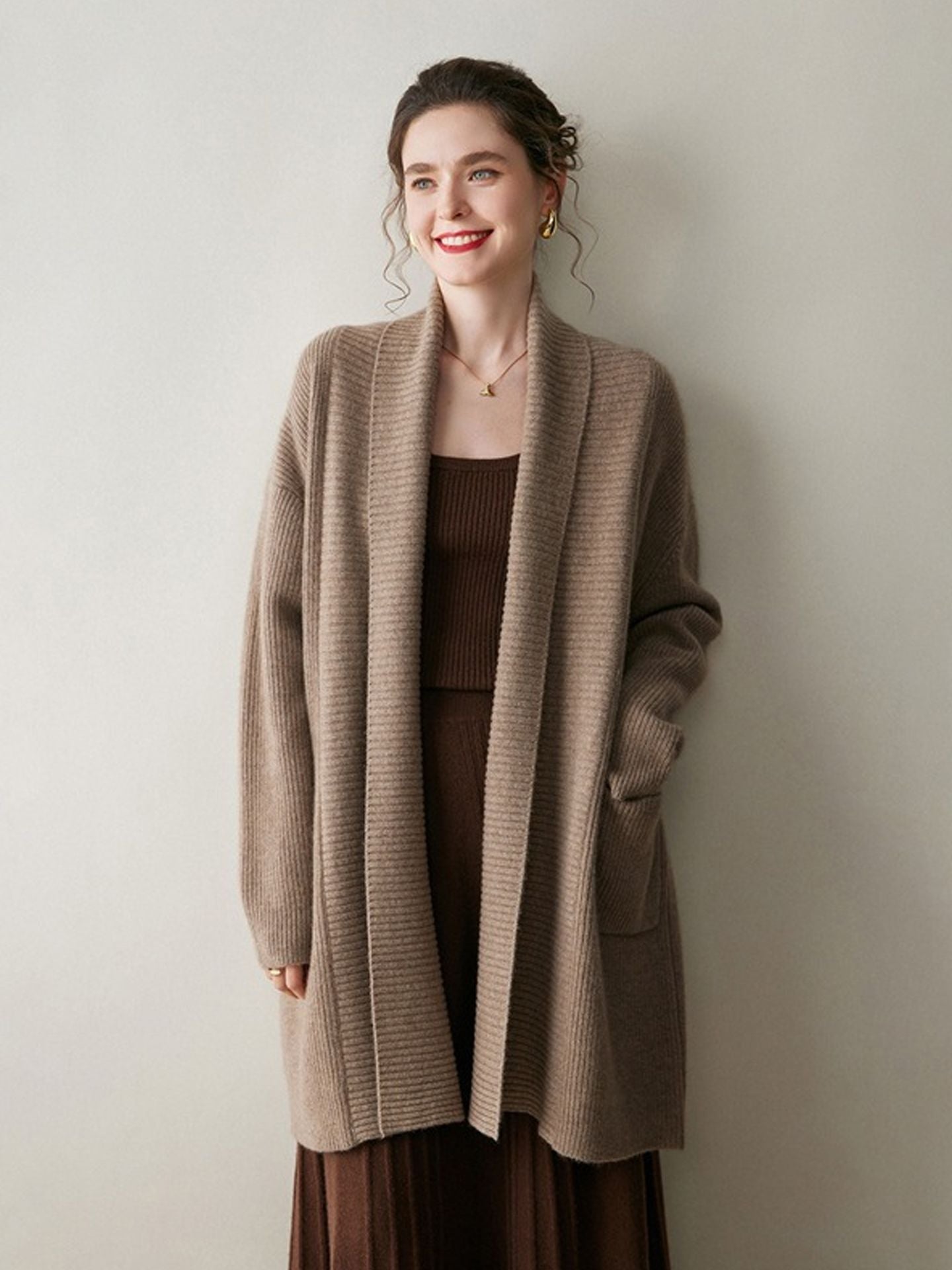 A stylish, mid-length knitted cardigan coat for women, designed with a sophisticated and elegant look perfect for autumn and winter.