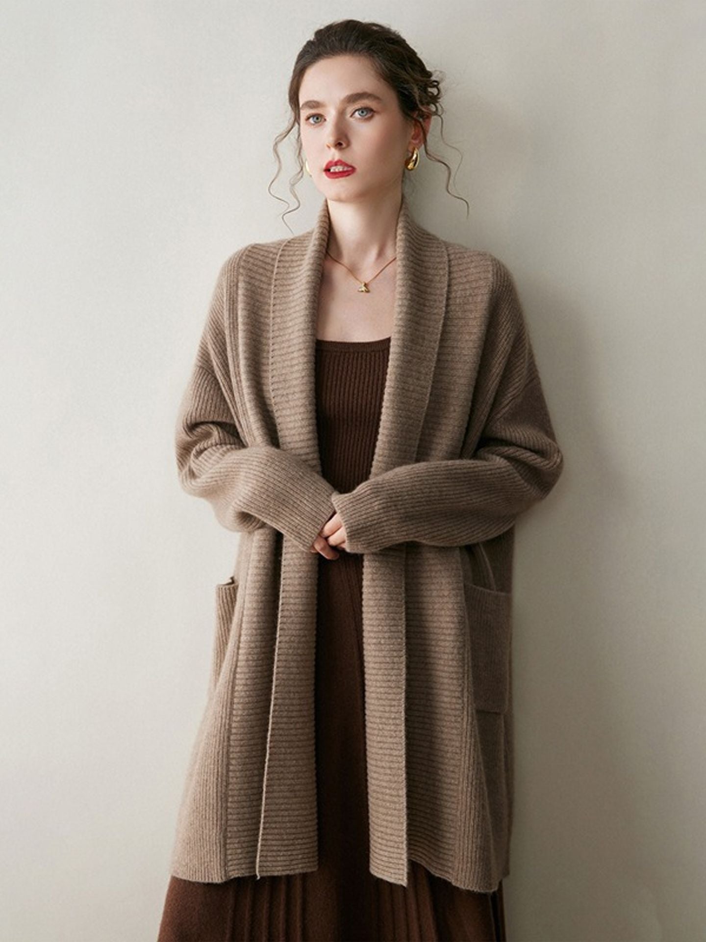A stylish, mid-length knitted cardigan coat for women, designed with a sophisticated and elegant look perfect for autumn and winter.