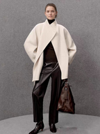 A stylish and sophisticated woolen coat with a waistband and a stand-up collar – perfect for women in autumn and winter.