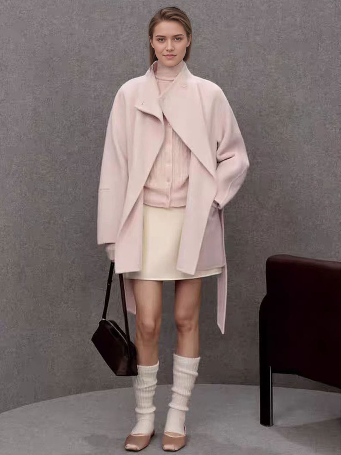 A stylish and sophisticated woolen coat with a waistband and a stand-up collar – perfect for women in autumn and winter.