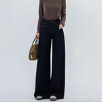 Dark blue denim trousers, high-waisted, straight-leg, wide-leg, perfect for early autumn and winter, with a flowing drape, ideal for spring and summer.