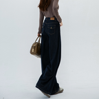 Dark blue denim trousers, high-waisted, straight-leg, wide-leg, perfect for early autumn and winter, with a flowing drape, ideal for spring and summer.