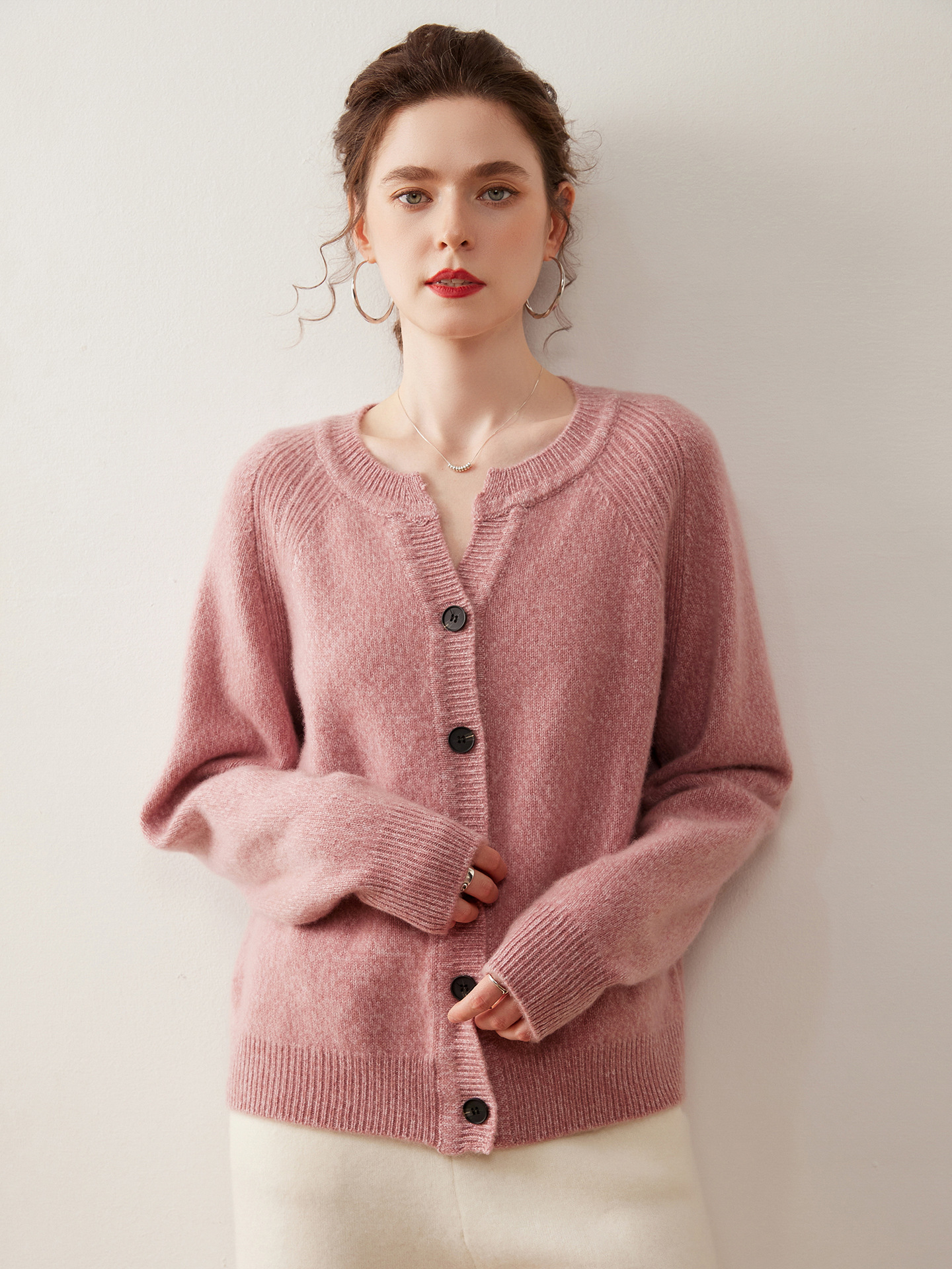 A stylish, slimming knitted sweater for women, made of cashmere-like material and featuring shoulder-cut sleeves and a round neckline.