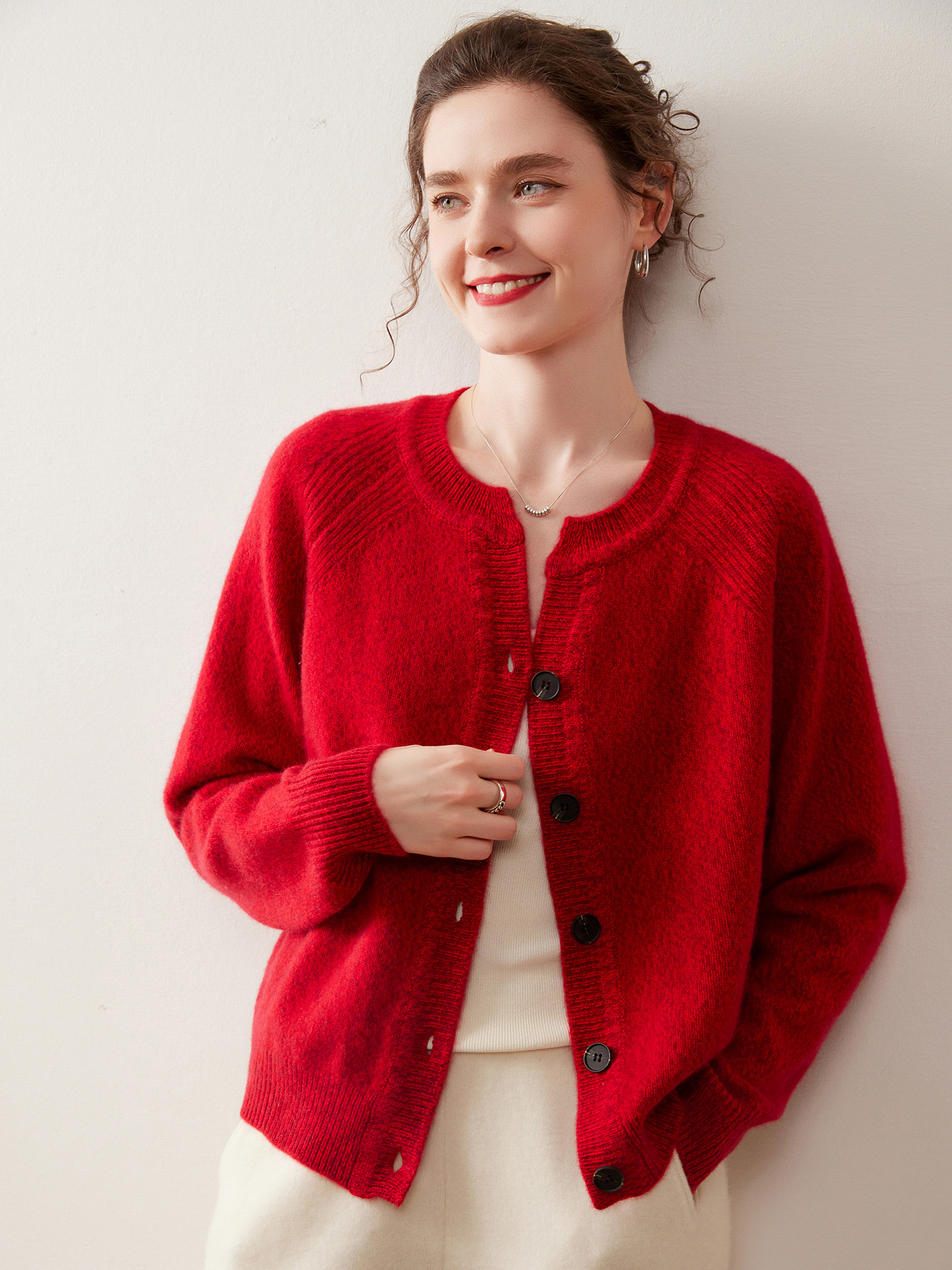 A stylish, slimming knitted sweater for women, made of cashmere-like material and featuring shoulder-cut sleeves and a round neckline.