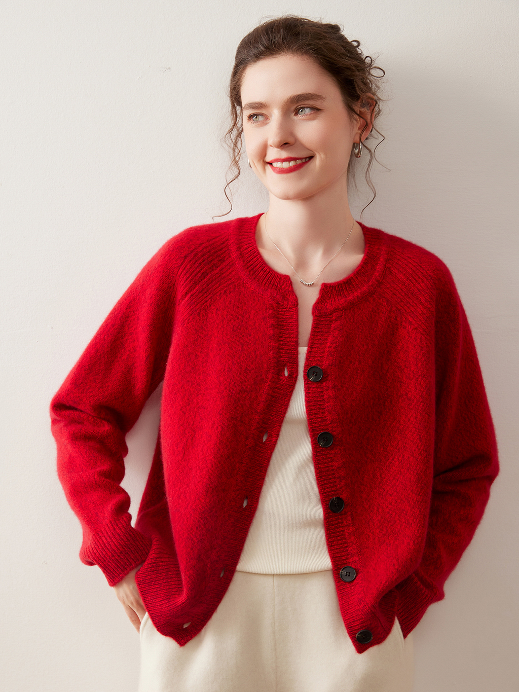 A stylish, slimming knitted sweater for women, made of cashmere-like material and featuring shoulder-cut sleeves and a round neckline.