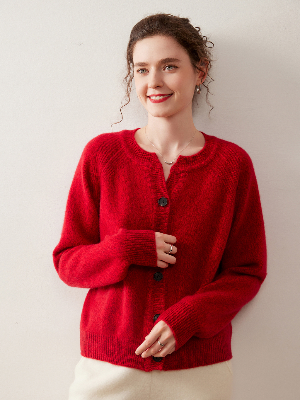 A stylish, slimming knitted sweater for women, made of cashmere-like material and featuring shoulder-cut sleeves and a round neckline.