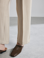 New autumn/winter style wide-leg trousers with a flattering, floor-length design. These trousers feature a milky-white color and a straight-leg design, giving them a stylish, almost suit-like look.