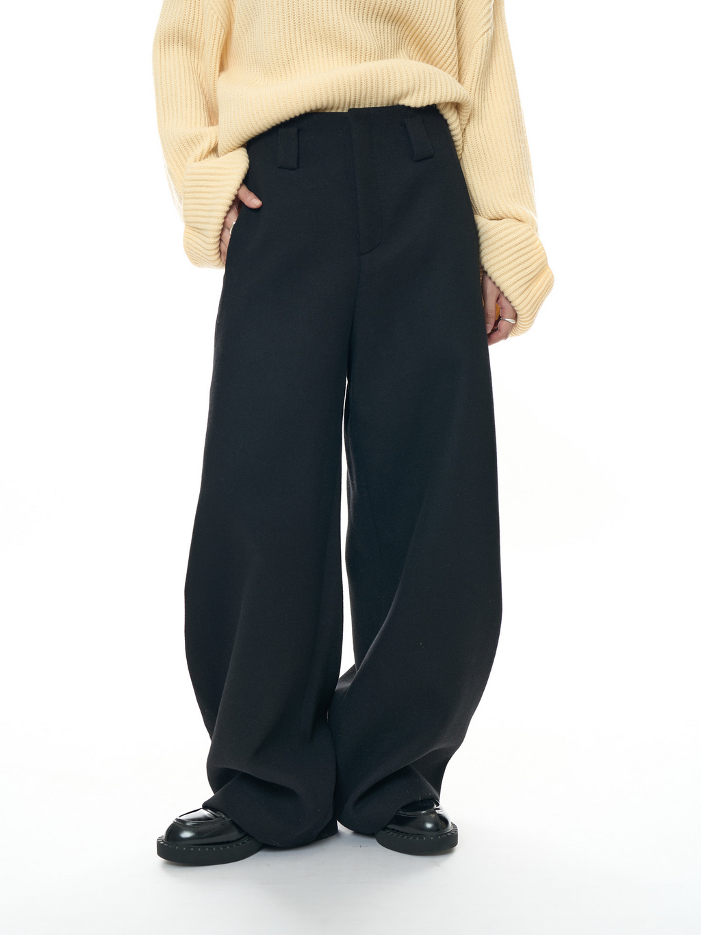 New, stylish woolen trousers with a curved cut – thick, warm, and featuring a relaxed, loose fit, perfect for women.