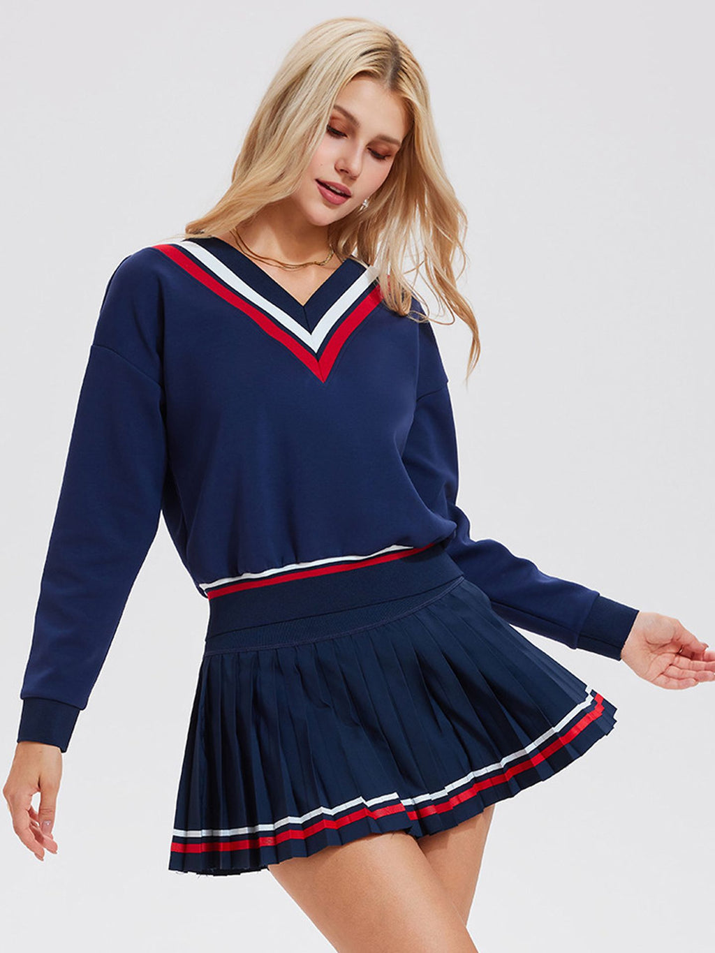 Long-sleeved sports top for women, designed for tennis play. Features a large V-neck and a stylish, casual design.
