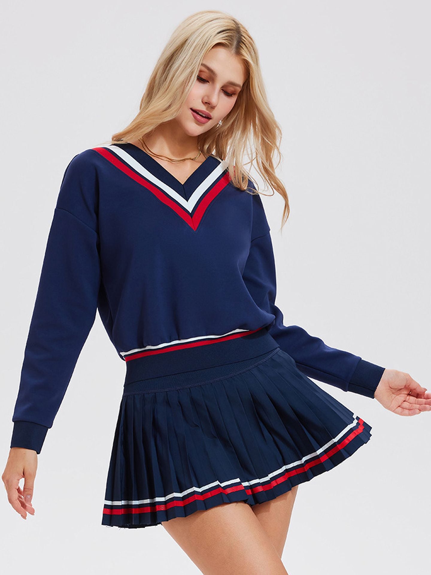 Long-sleeved sports top for women, designed for tennis play. Features a large V-neck and a stylish, casual design.