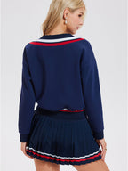 Long-sleeved sports top for women, designed for tennis play. Features a large V-neck and a stylish, casual design.