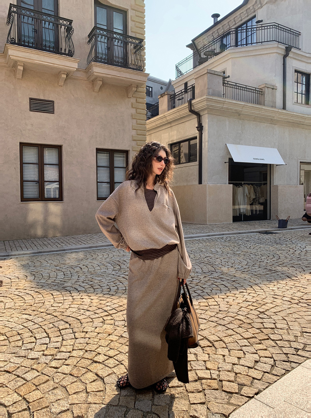 A stylish and fashionable outfit for women: a fake two-piece hoodie paired with a skirt.