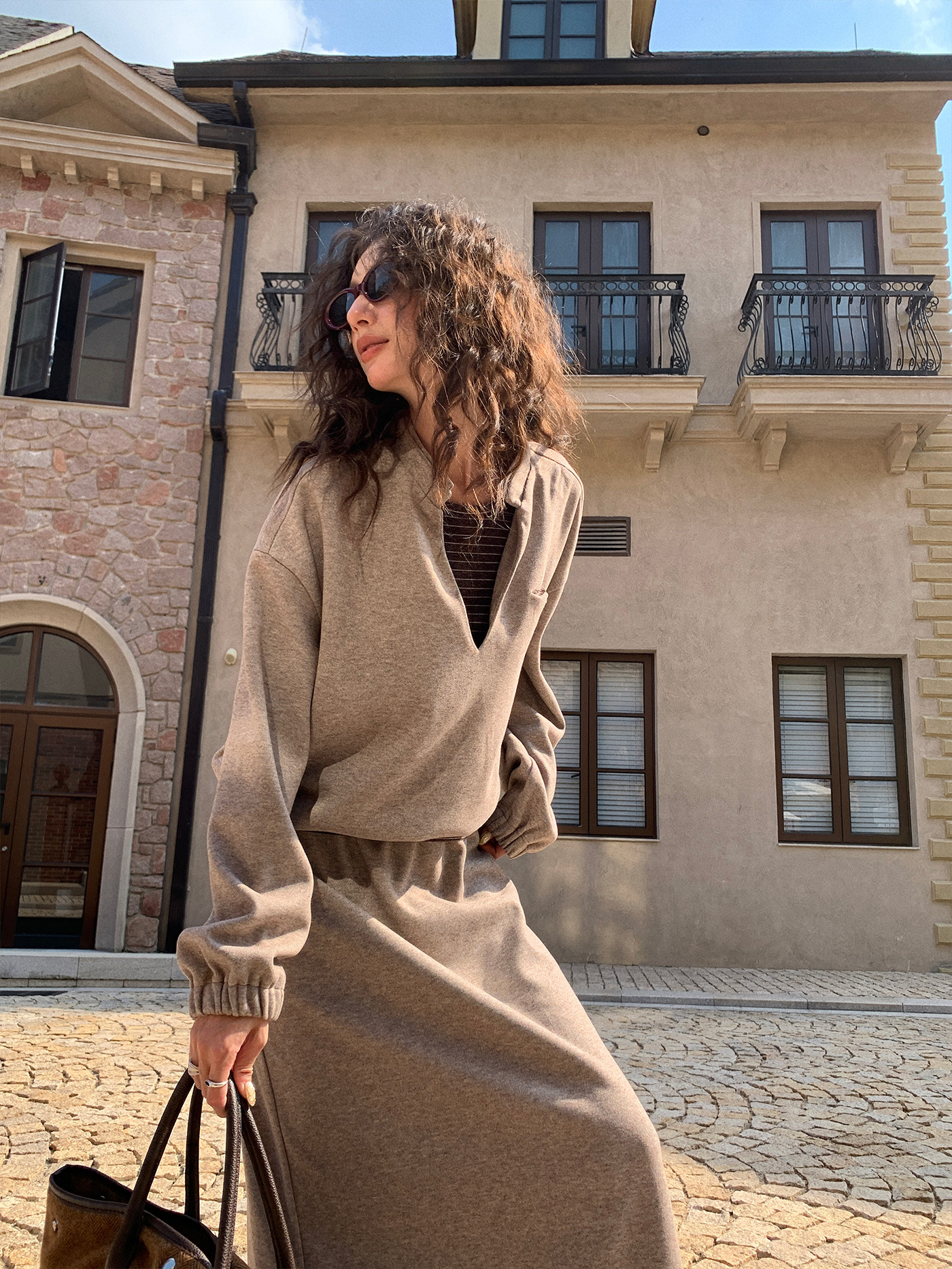 A stylish and fashionable outfit for women: a fake two-piece hoodie paired with a skirt.