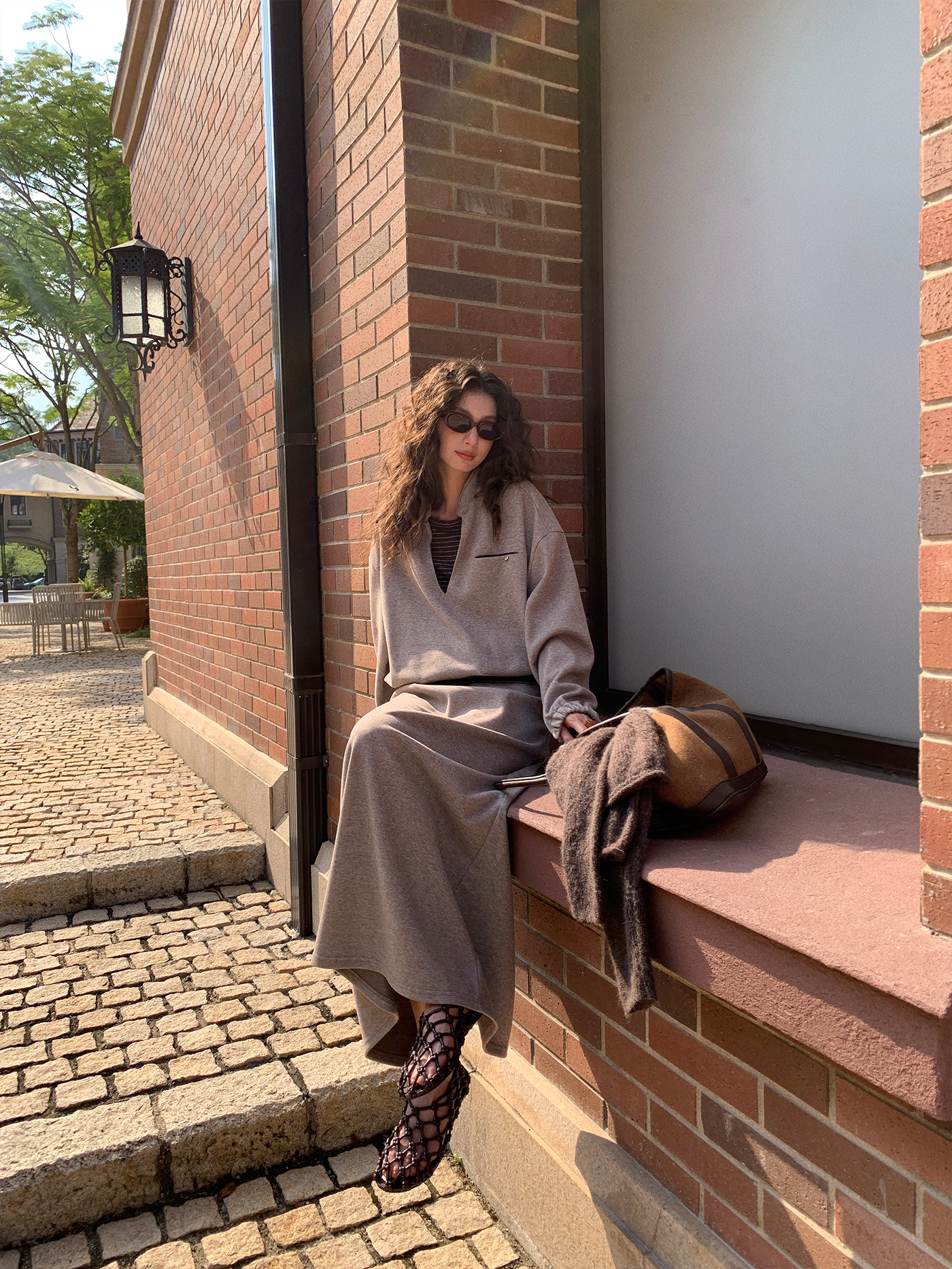 A stylish and fashionable outfit for women: a fake two-piece hoodie paired with a skirt.